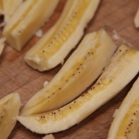 Step 1 - Cut bananas in half than in quarters